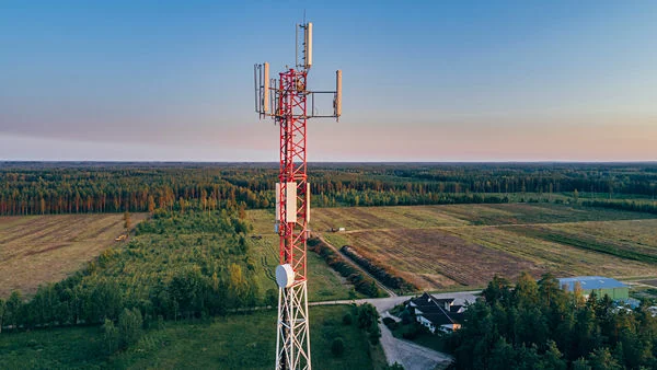Cell phone tower with field in background